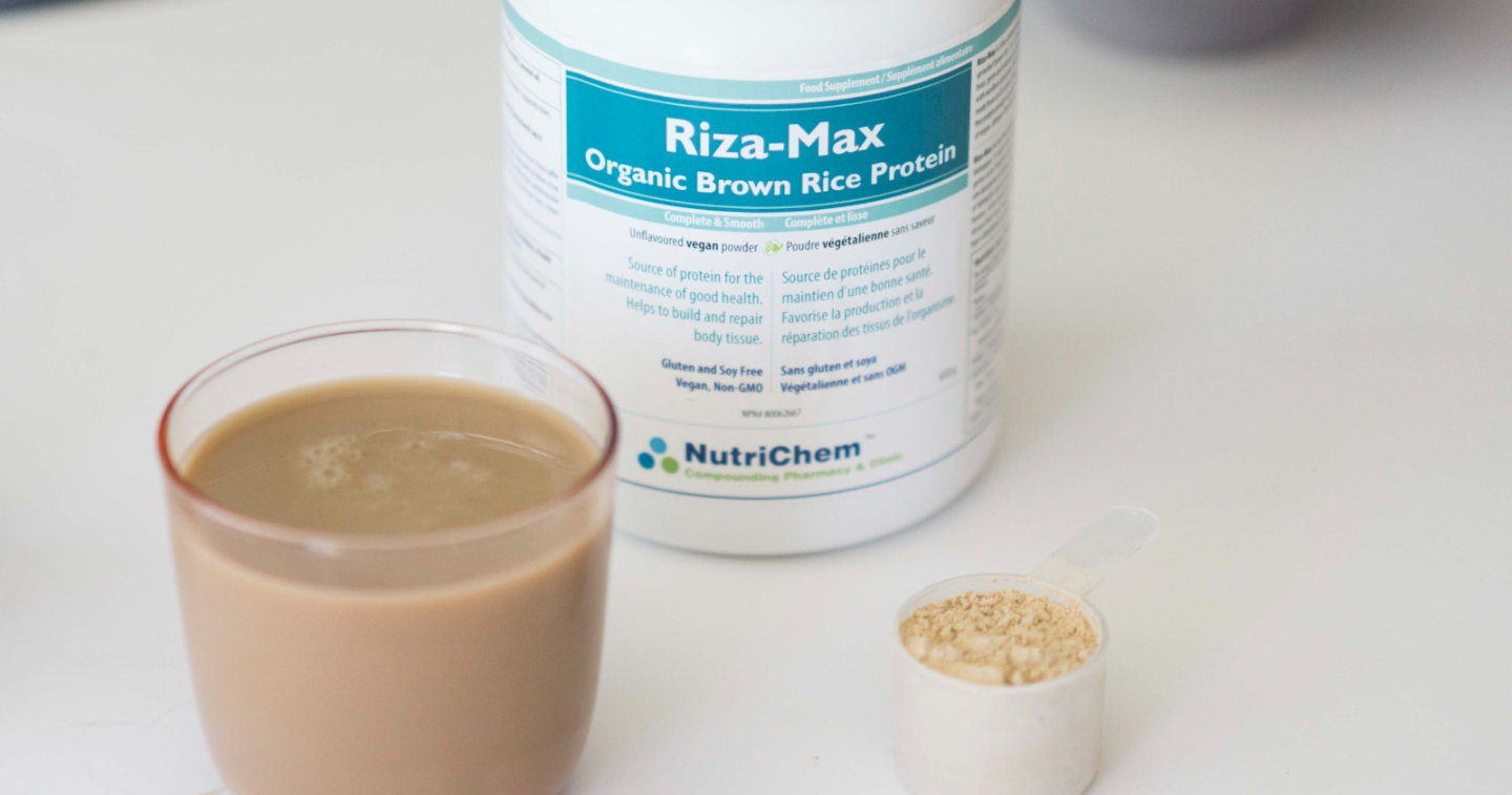 Riza-Max Organic Brown Rice Protein bottle and glass mixture next to it