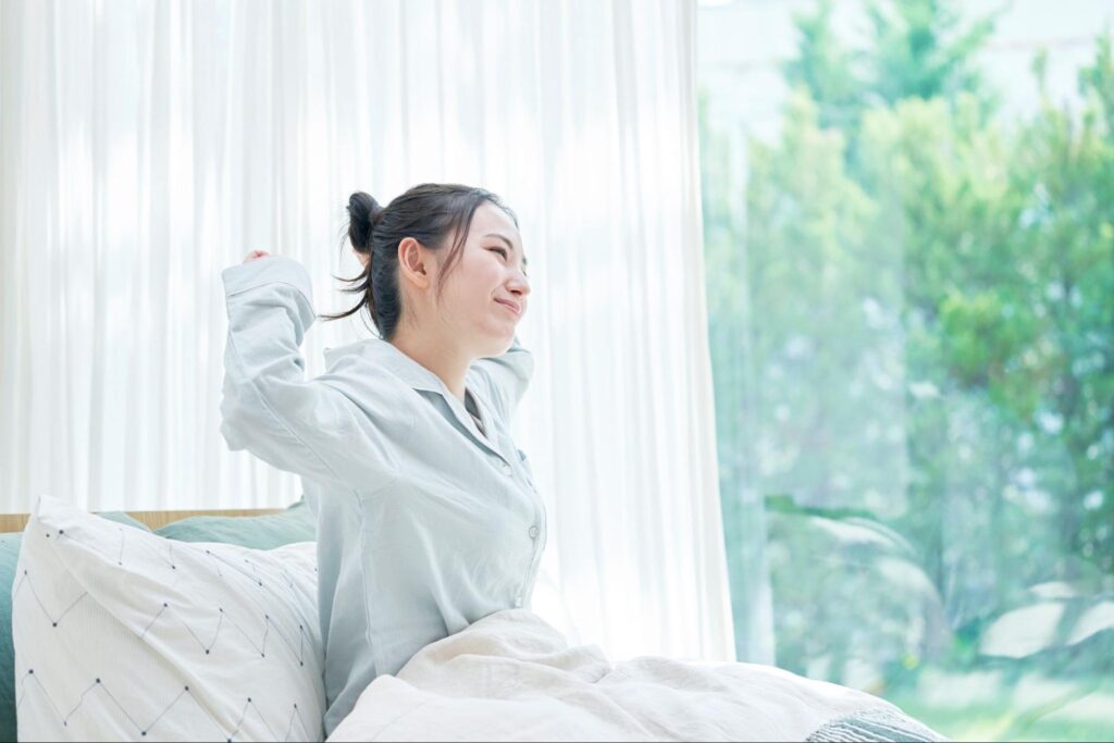woman waking up feeling healthy overall
