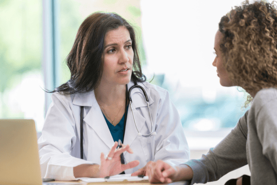 woman speaking to doctor